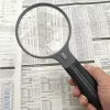 Lupa Carson Split Handle HF-11 — ručná lupa 3,5×, čierna/priehľadná, batéria AAA